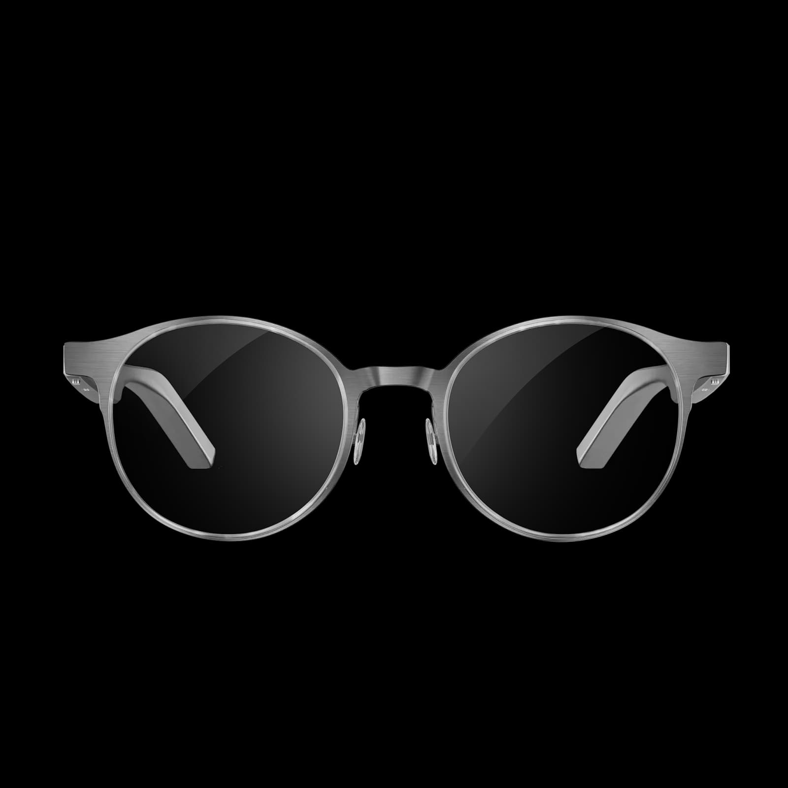 Dymesty AI Glasses en titanio cepillado gris, montura redonda de metal sola en vista frontal sobre fondo blanco.