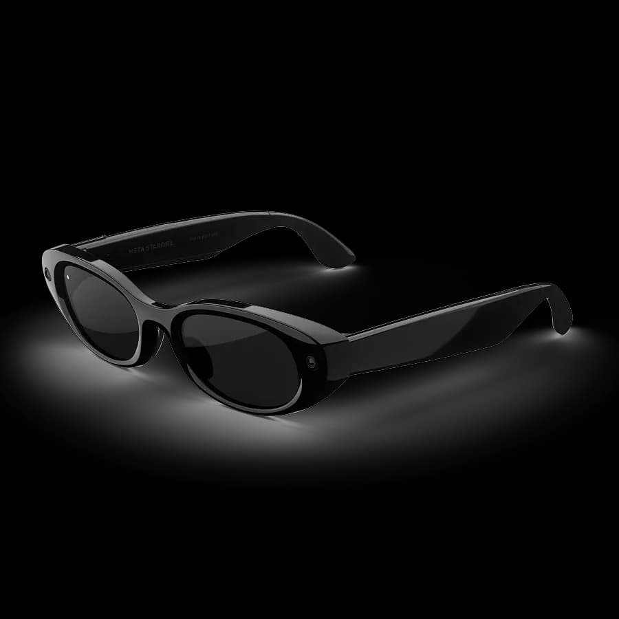Meta Glasses Starfire at an angle, black oval frame with 'Meta Starfire' printed on the temple and a camera lens near the hinge.