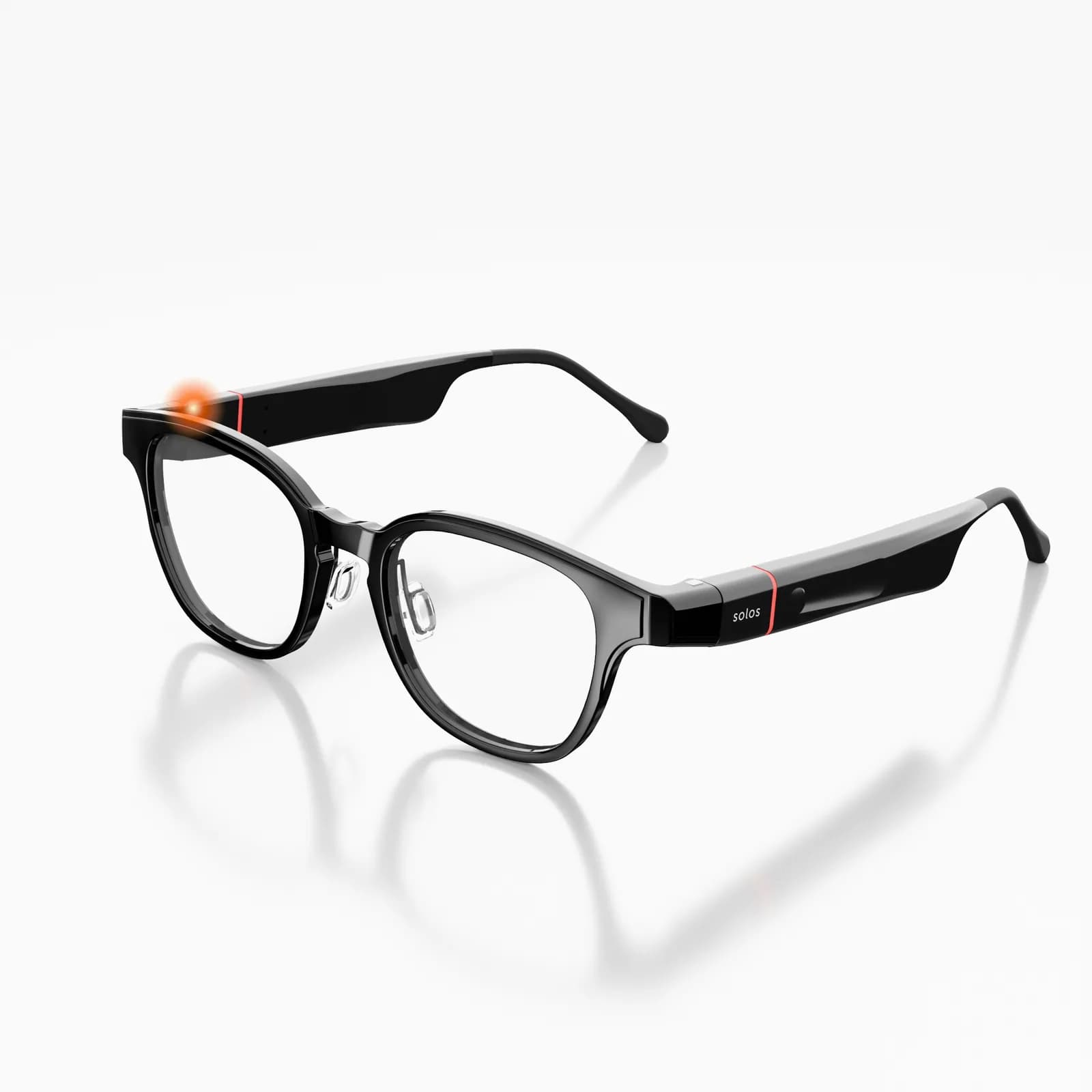 Gafas Solos AirGo 3 en negro sólido, montura redonda con cristales transparentes, en ángulo, con la línea roja en la patilla.