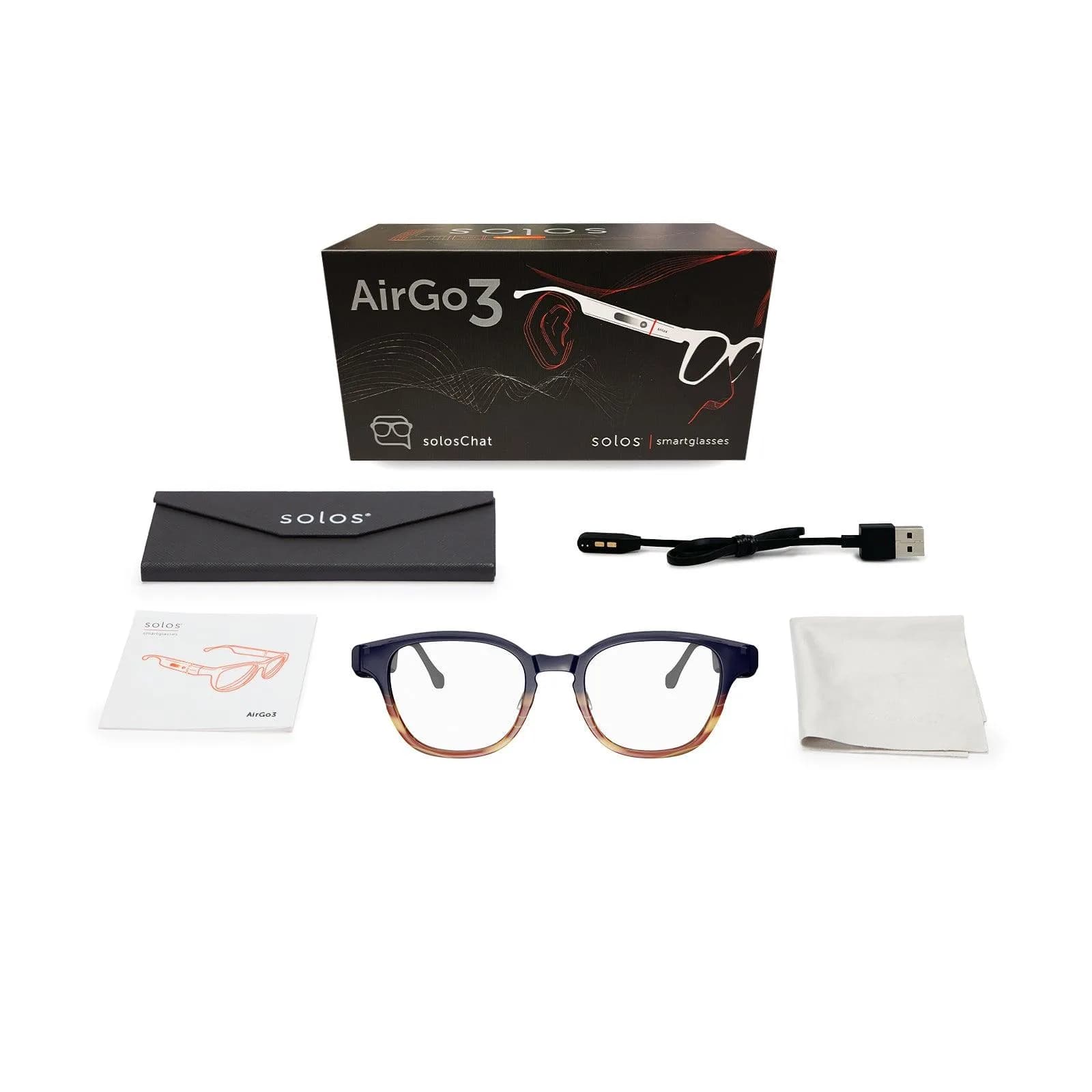 Kit de venta del Solos AirGo 3 dispuesto en plano: la caja, un estuche, cable USB de carga, manual, las gafas y un paño de limpieza.