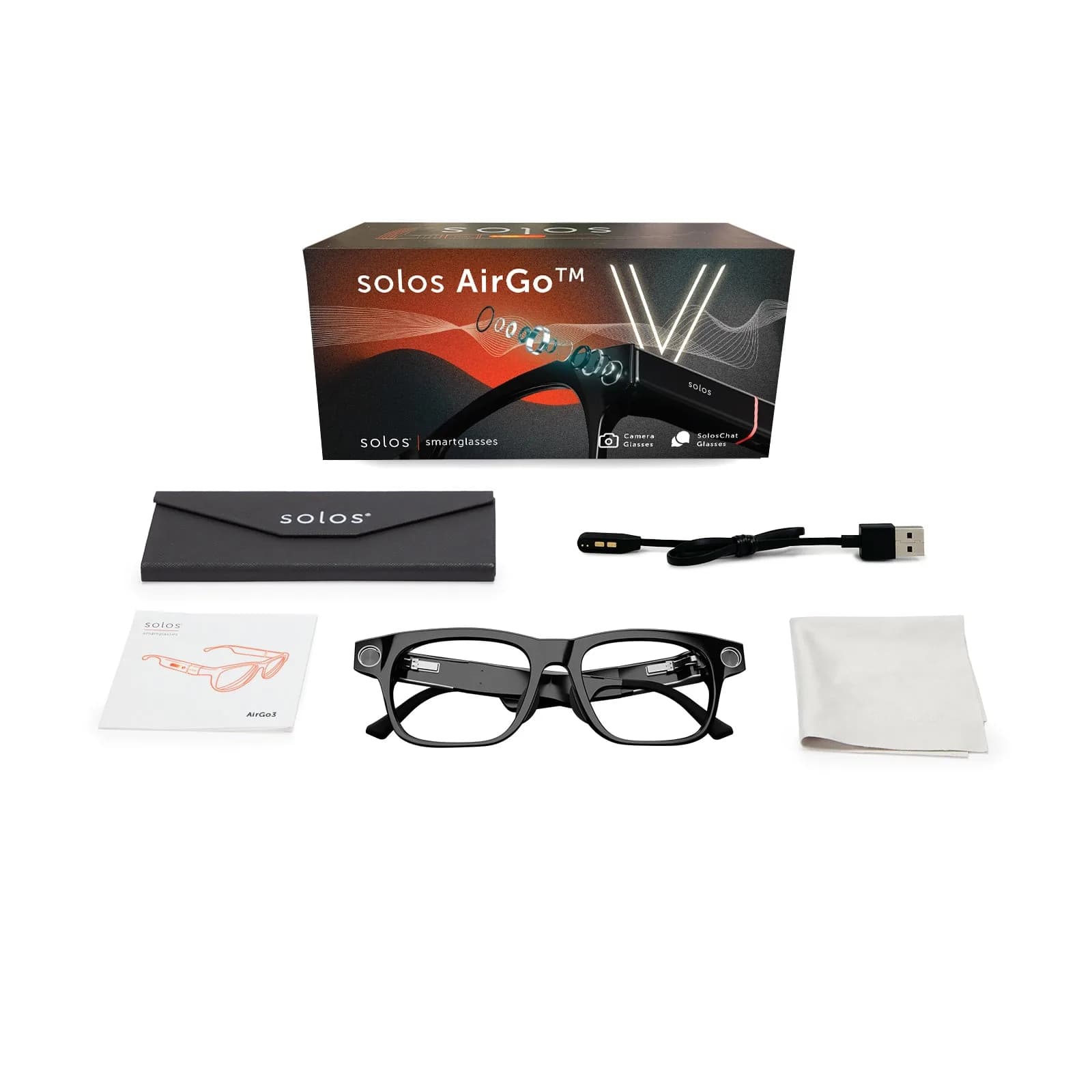 Kit de venta del Solos AirGo Vision dispuesto en plano: la caja, un estuche, cable USB de carga, manual, las gafas negras y un paño de limpieza.