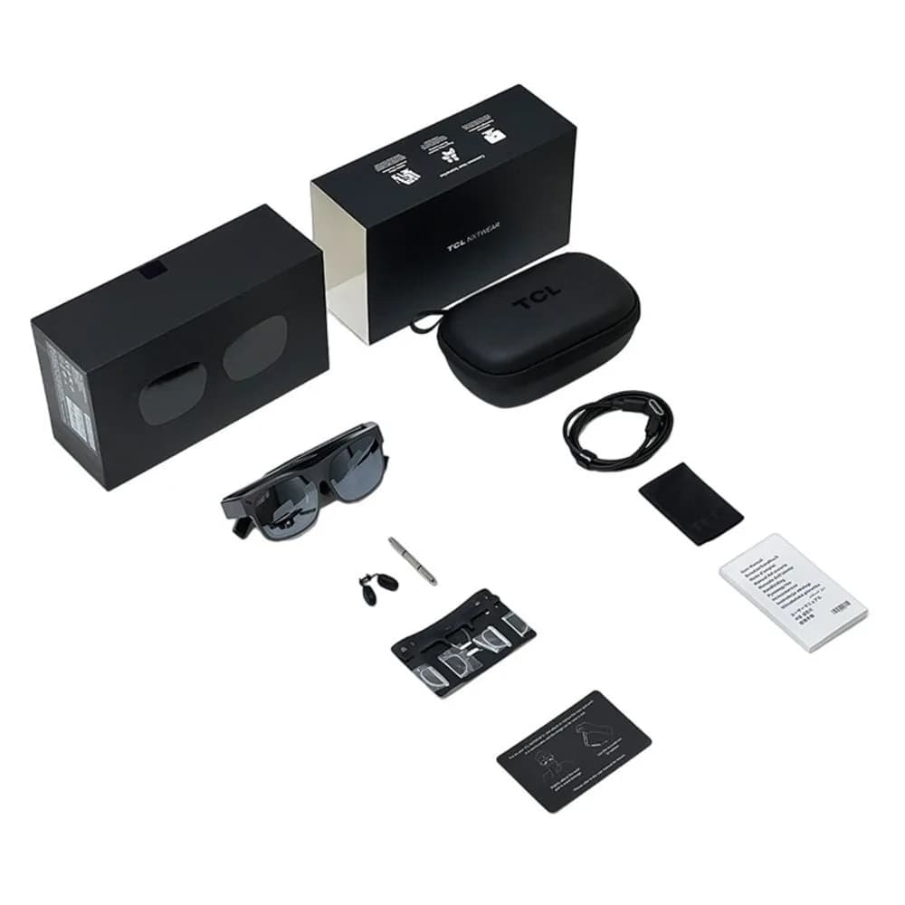 TCL NXTWEAR S+ retail kit laid out flat: two boxes, a zippered case, USB-C cable, cloth, nose pads, and the glasses.