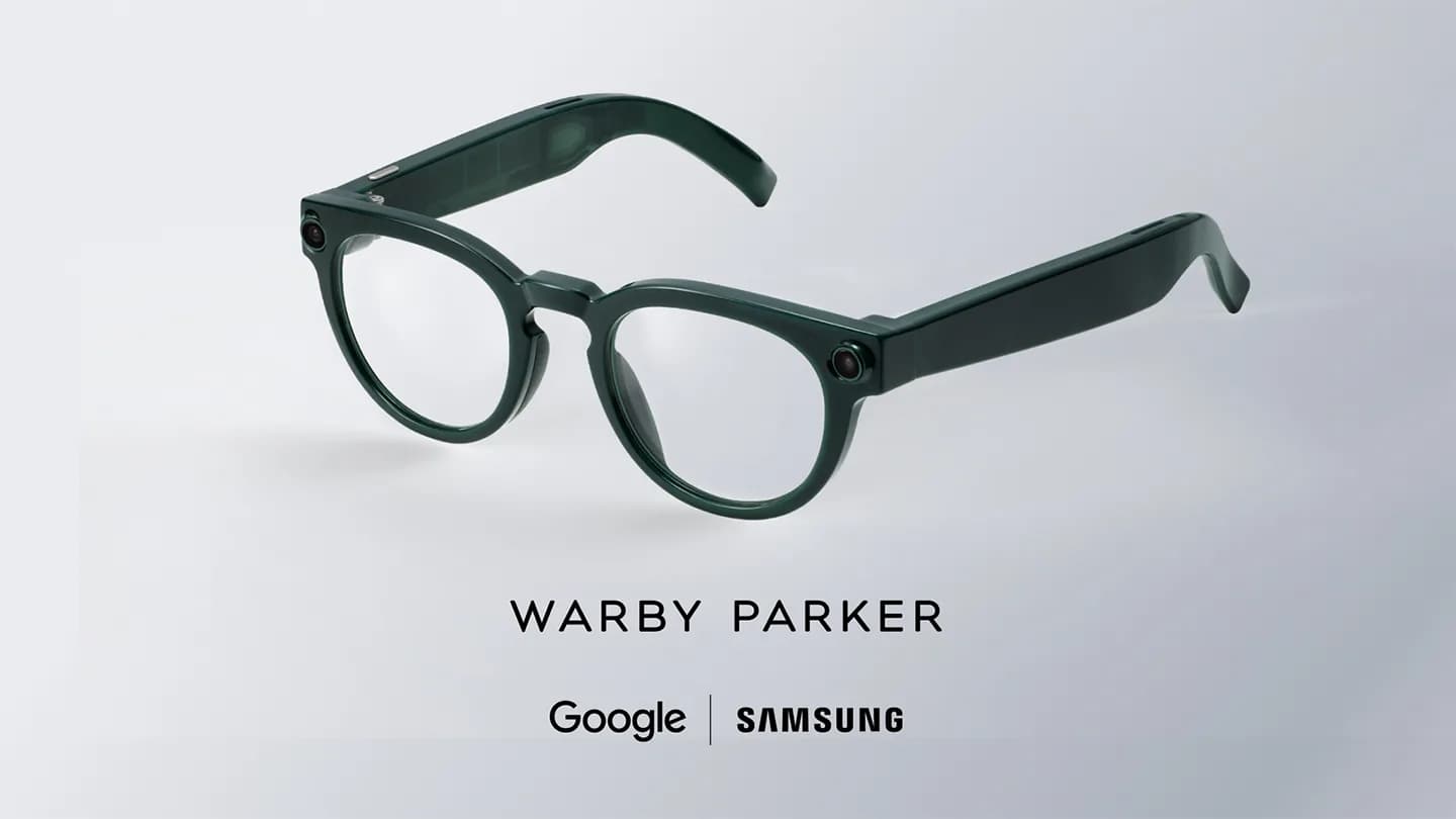 Warby Parker Intelligent Eyewear in dark green, round frame with a small camera lens near each hinge, on a gray background.