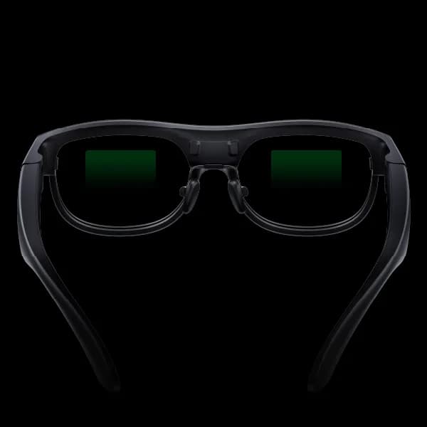 Gafas XRAI AR2 en negro, montura gruesa y redondeada vista de frente, con una pantalla verde encendida en cada lente.