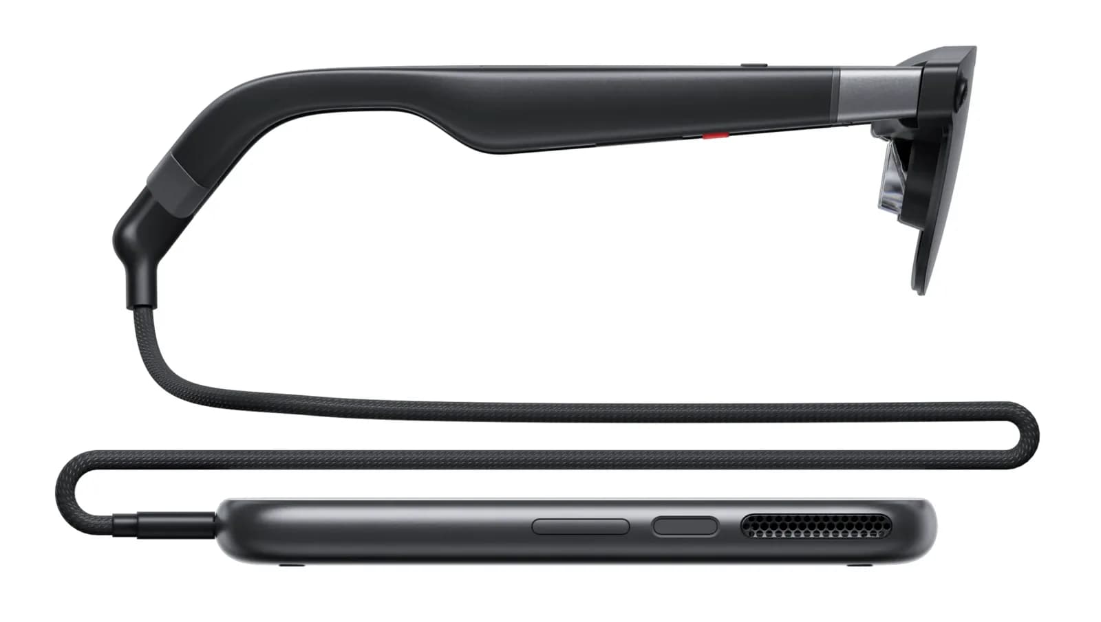 XREAL Aura glasses in profile, in black, connected by a cable to a black cylindrical compute puck on a white background.