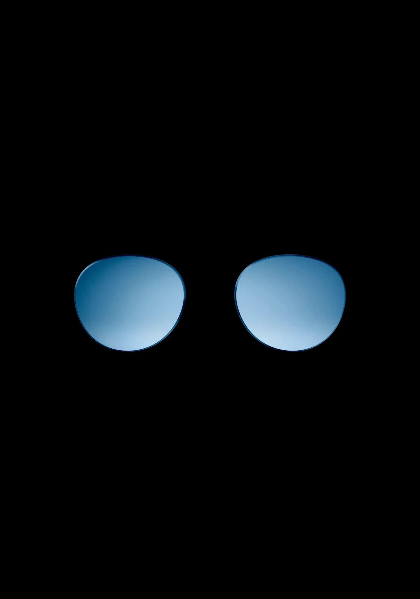 Bose Frames replacement lenses alone, a round pair with a blue mirrored tint and no frame around them.