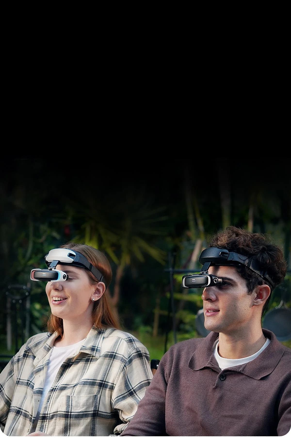 GOOVIS Art worn on the foreheads of two people, one in white and blue, the other in black, the visor hanging in front of their eyes.