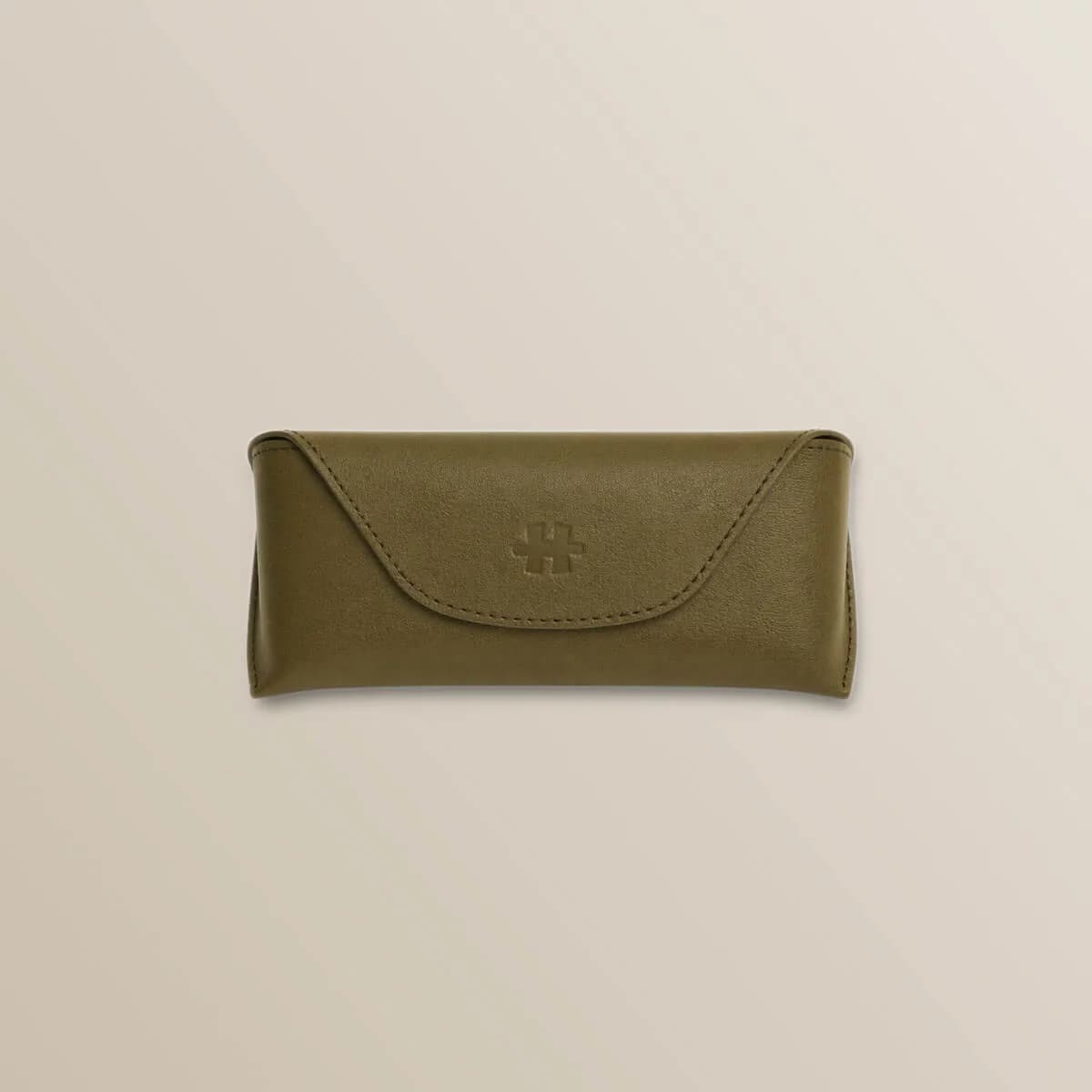 Halliday G2 carrying case in olive green leather, closed clamshell shape with an embossed logo, on a cream background.