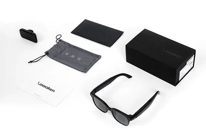 LAWK View accessories laid out: a black charging case, a drawstring pouch, a cleaning cloth, the retail box, and the folded glasses.