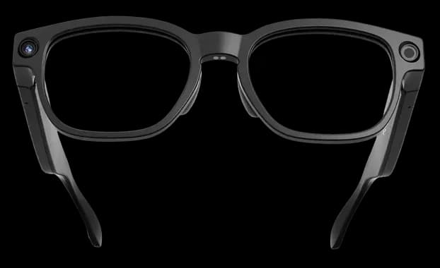 Mentra Live glasses in black, front view with a small camera lens on each top corner of the frame.