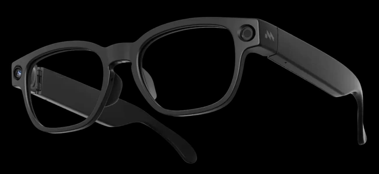 Mentra Live glasses in black, three-quarter view with a camera lens on the top corner and an M logo on the temple.