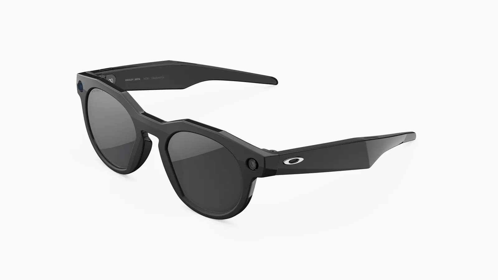Oakley Meta HSTN glasses in matte black, round frame with dark lenses, a small camera at the left hinge and the Oakley logo on the right temple.