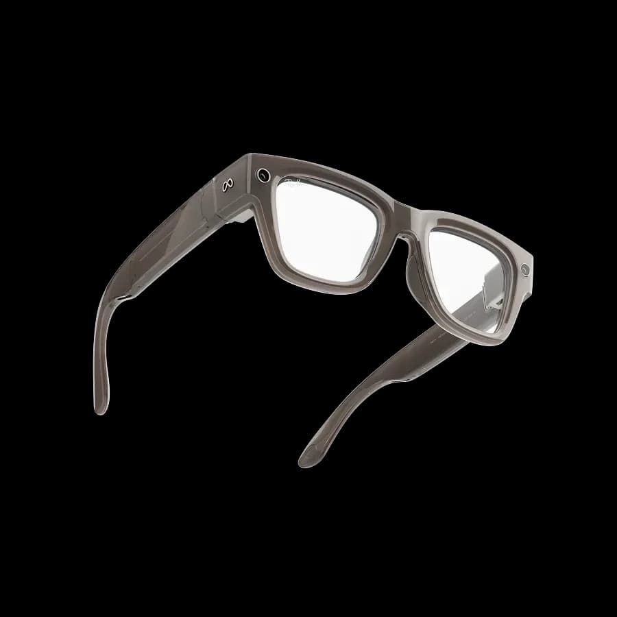 Meta Ray-Ban Display glasses in translucent grey, square frame with clear lenses and a small camera on the left temple, on a white background.