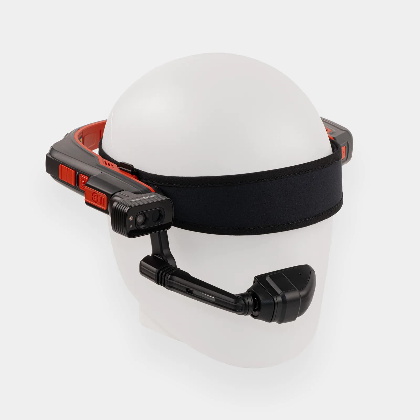 RealWear Navigator Z1 headset in red and black, fitted on a plain white head form with the boom arm hanging over the face.
