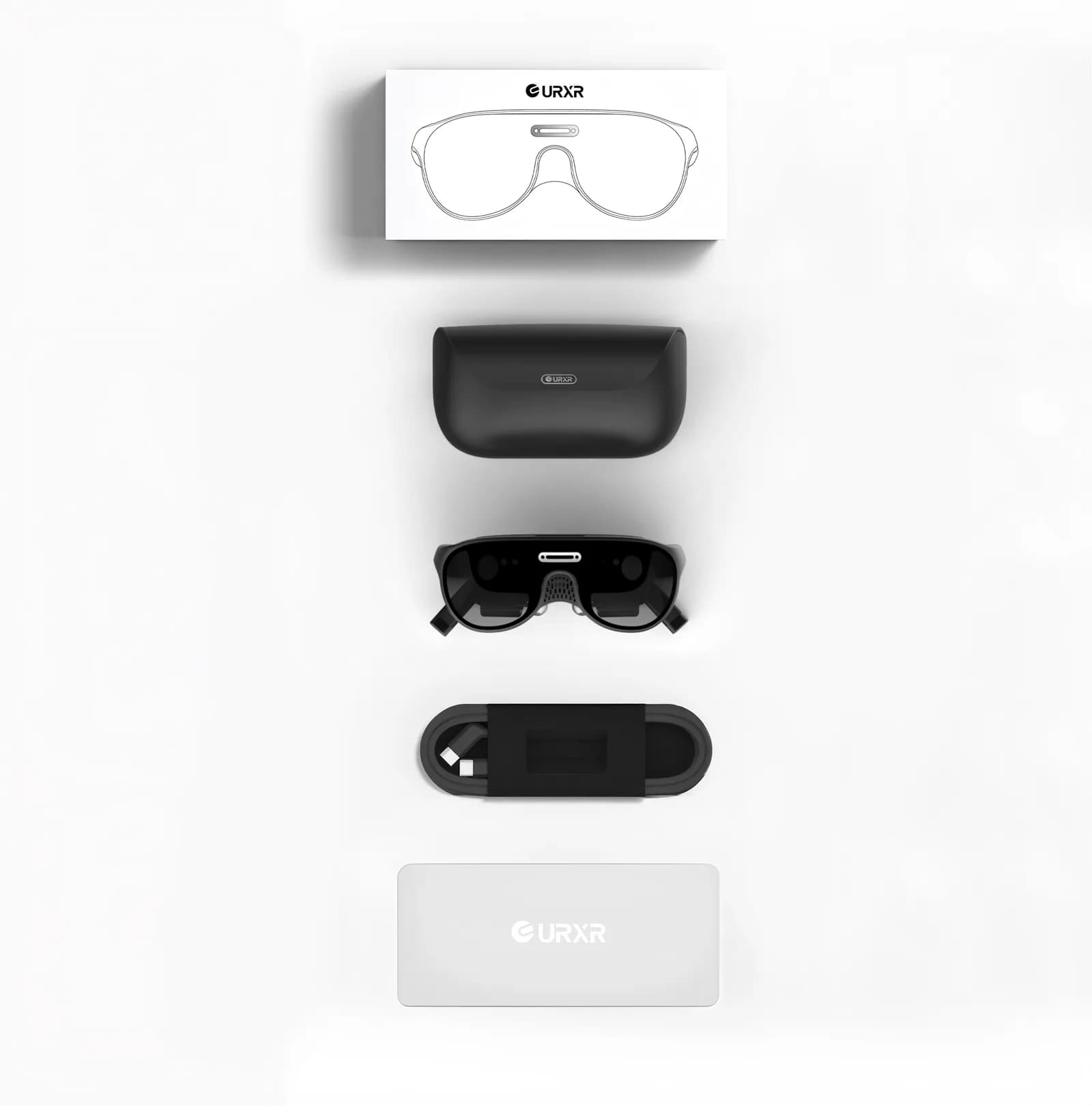 Unseen Reality URXR One retail kit laid out: white box, black hard case, the black glasses, a coiled cable, and a white power hub.