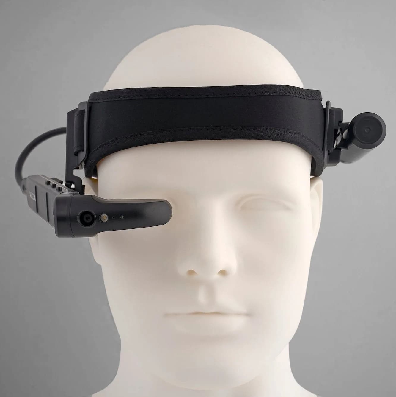 Vuzix M400 headset on a mannequin head, black camera and display arm swung down over the right eye.