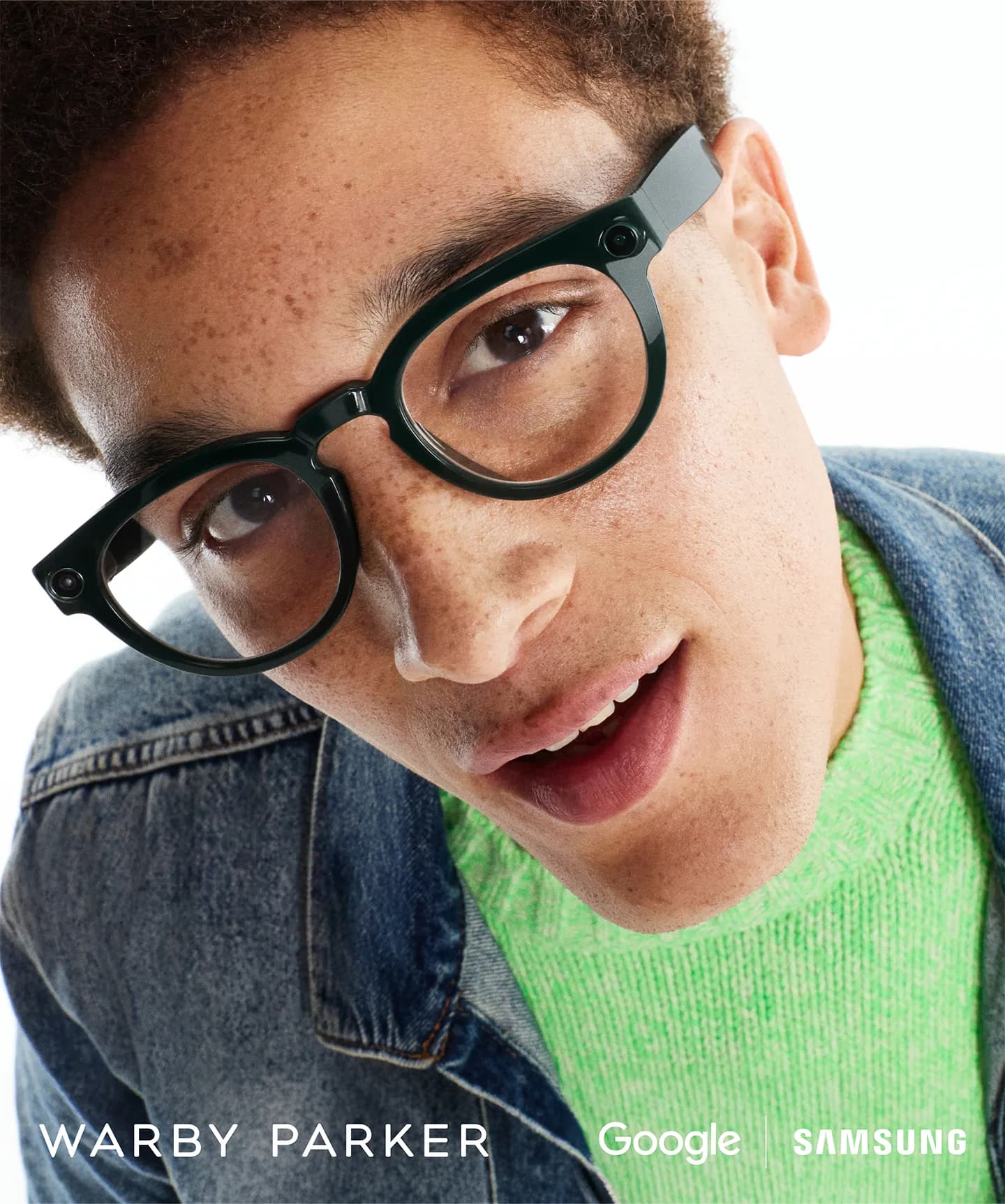 Warby Parker Intelligent Eyewear worn by a young man in a denim jacket, close on the round frame and hinge camera.