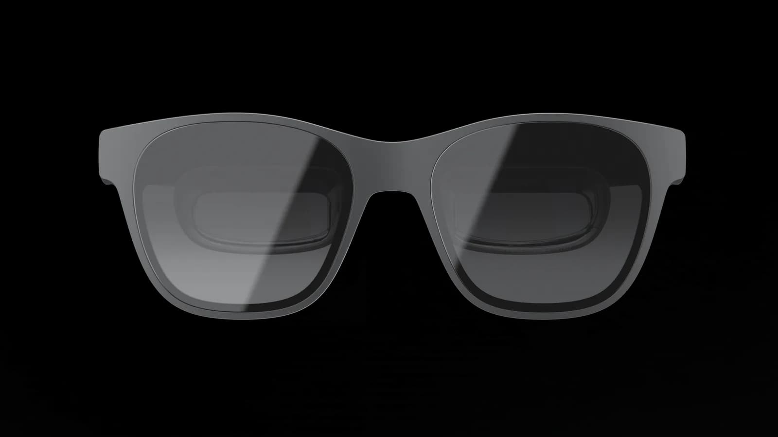 XREAL Air 2 glasses in dark gray, seen from the front on a plain background, with a thick square frame and dark gradient lenses.